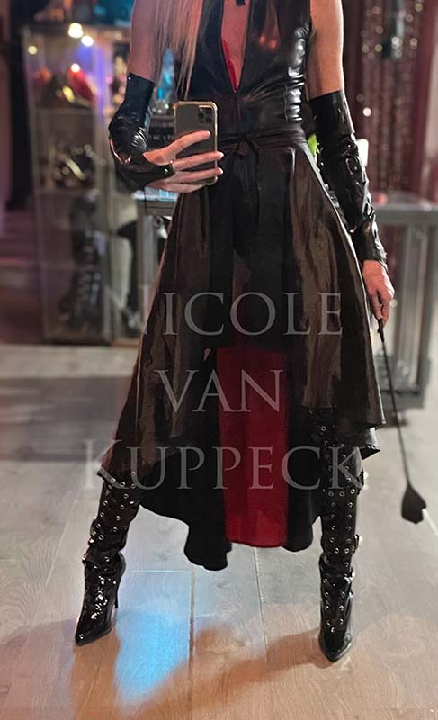 Sexy Dominatrix boots under a red and black skirt - crop in hand